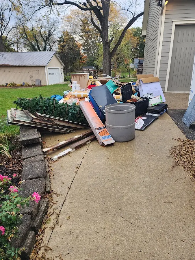Dumpster being loaded with debris for 12 Yard Dumpster Rental in Sebring